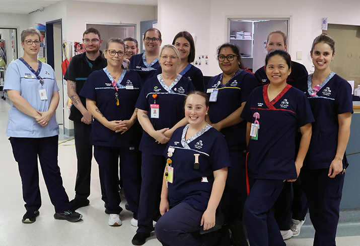 A dozen members of the Peel Health Campus Whelan Ward nursing staff standing together in the ward